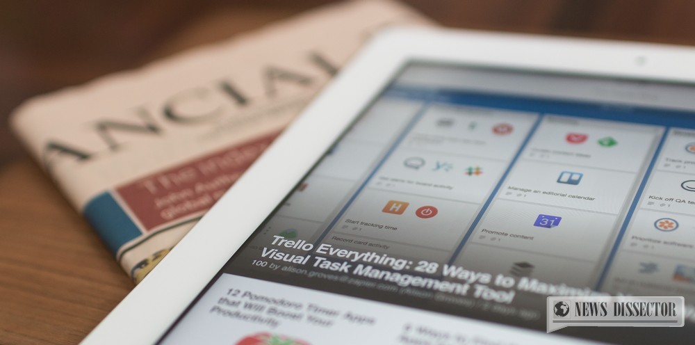 A tablet placed on top of a newspaper