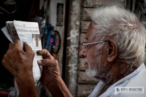 An old man reading an article