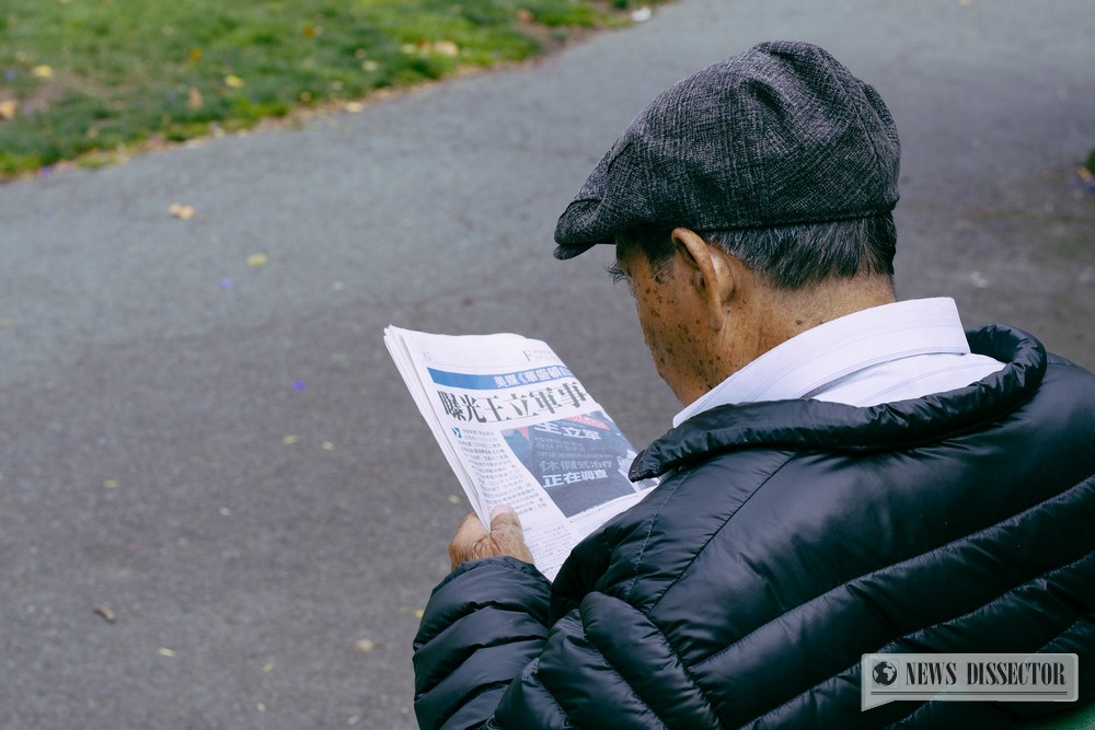 Old man reading a newspaper