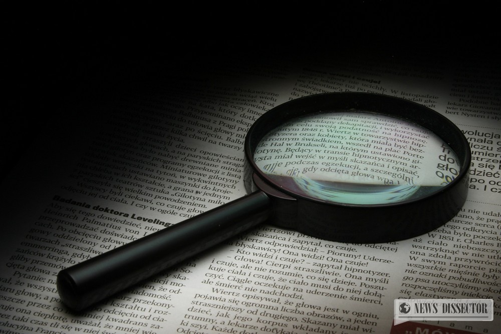 A magnifying glass over a newspaper