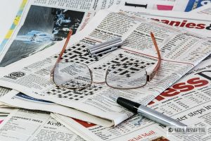 Newspaper with glasses and pen